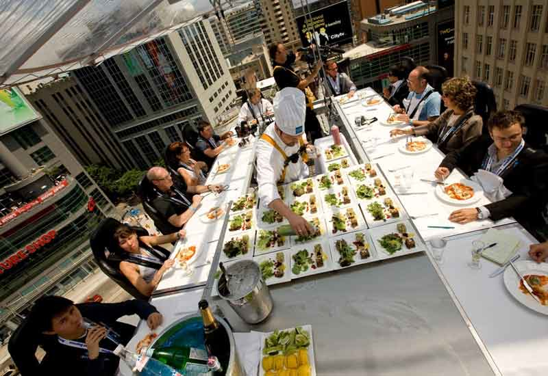 A Dinner in the Sky chef impresses his guests. A Dinner in the Sky chef impresses his guests.